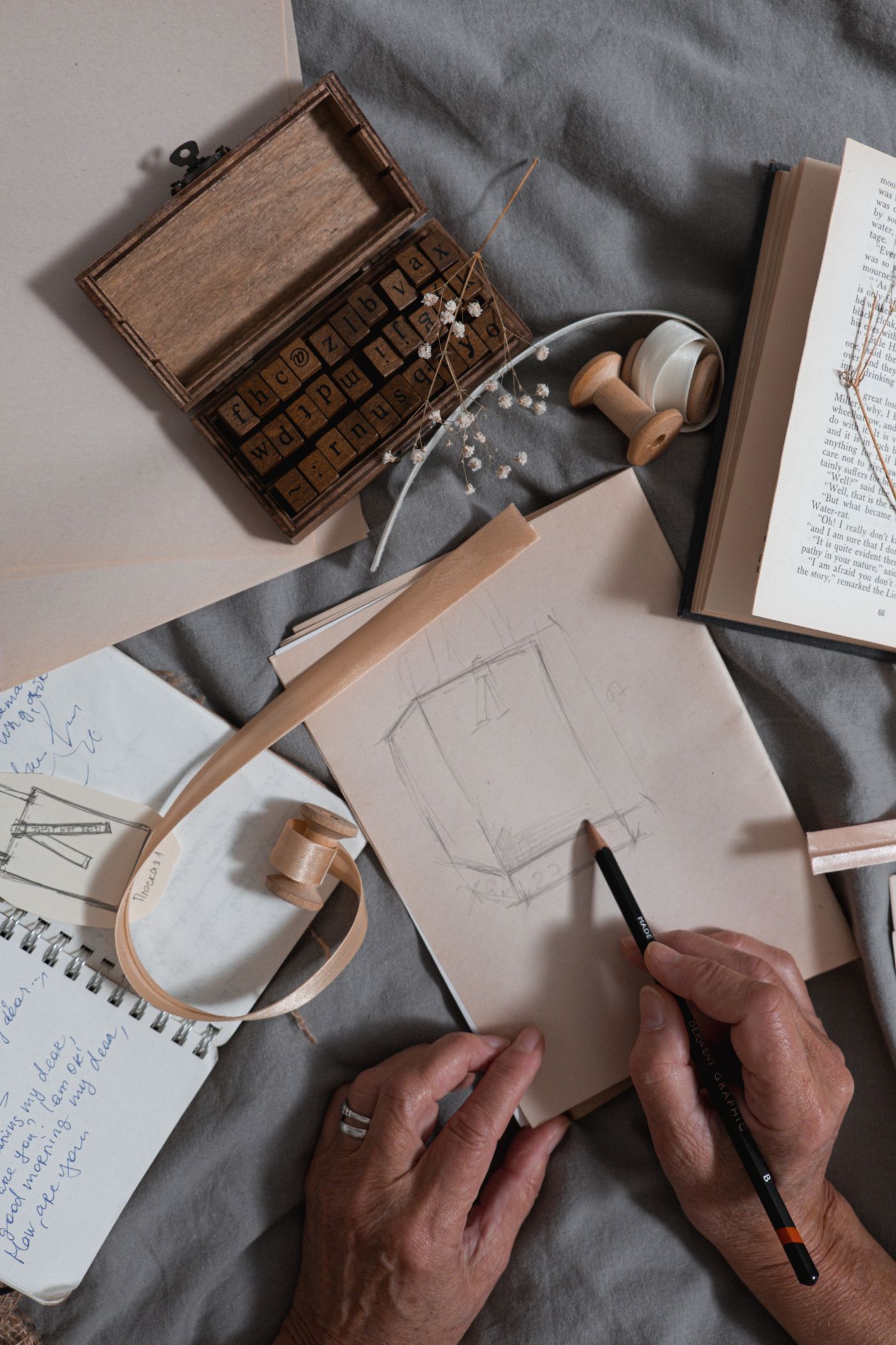 A creator drawing an apparel concept on paper.
